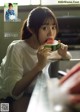 A woman eating a slice of watermelon in a magazine.